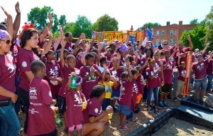 Volunteers join with Mercy Housing children to celebrate the completion of the playground. Photo Credit: Daniel Olsen 